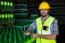 Portrait of man with digital tablet standing in warehouse — Stock Photo