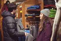 Couple selecting apparel together in a clothes shop — Stock Photo