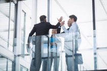 Group of business people giving high five inside office building — Stock Photo