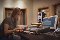 Audio engineer using digital tablet in recording studio — Stock Photo