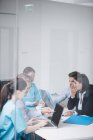 Doctors discussing over laptop in meeting at conference room — Stock Photo