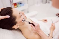 Dermatologist performing laser hair removal on patient face in clinic — Stock Photo