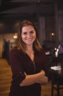 Portrait of a beautiful woman smiling in bar — Stock Photo