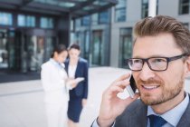 Confident businessman talking on mobile phone — Stock Photo
