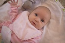 Close-up of cute baby lying on bed sheet at home — Stock Photo