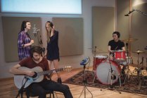 Music band performing in recording studio — Stock Photo