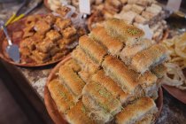 Close-up of turkish sweets in plate on display at counter in shop — Stock Photo
