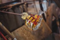 Close-up of showpiece figure made from a molten glass at glassblowing factory — Stock Photo