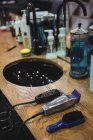 Various beauty products and barber tools on dressing table in barbershop — Stock Photo