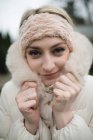 Portrait of woman in furry coat feeling cold — Stock Photo