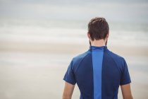 Rear view of athlete standing on beach — Stock Photo