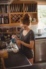 Woman preparing coffee in kitchen at home — Stock Photo