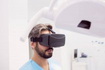 Dentista che utilizza cuffie realtà virtuale in clinica dentale — Foto stock