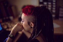 Close-up of female hairdresser using laptop in dreadlocks shop — Stock Photo