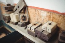 Moldes de madeira para sopro de vidro dispostos na prateleira na fábrica de sopro de vidro — Fotografia de Stock