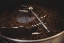 Coffee beans being grinded in coffee grinding machine — Stock Photo
