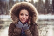 Portrait of beautiful young woman in fur coat — Stock Photo