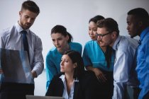 Medical team examining an x-ray report in conference room — Stock Photo