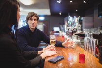 Couple having champagne and beer together in bar — Stock Photo