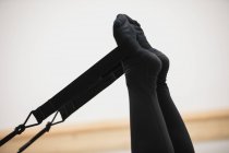 Close-up of woman exercising on reformer in gym — Stock Photo