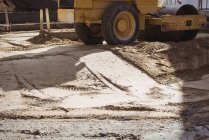 Road roller levelling  soil at construction site — Stock Photo