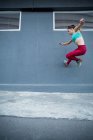 Woman practicing parkour on the street — Stock Photo