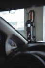 Plug-in-Elektromaschine durch Autoscheibe an Elektrofahrzeug-Ladestation gesehen — Stockfoto