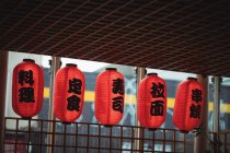 Japanese lanterns hanging in a row at restaurant — Stock Photo