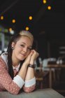 Portrait of smiling woman sitting in cafe — Stock Photo