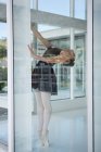 Ballerina practicing ballet dance near window in the studio — Stock Photo