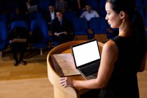 Female business executive giving a speech at conference center — Stock Photo