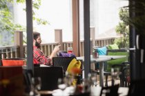 Mann benutzte Handy mit Weinglas auf Tisch in Bar — Stockfoto