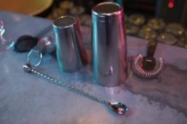 Close-up of bar accessories with cocktail shaker and spoon — Stock Photo