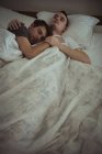 Gay couple embracing while sleeping on bed in bedroom — Stock Photo