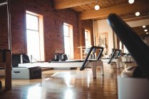 Pilates exercise equipment on wooden floor in fitness studio — Stock Photo