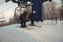 Two skiers travelling in ski lift at ski resort during winter — Stock Photo