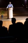 Business executive giving a speech at conference center — Stock Photo