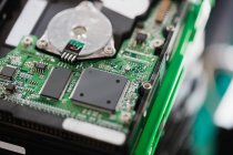 Close-up of an opened hard drive in repair shop — Stock Photo
