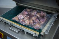 Close-up of vacuum packaging machine at meat factory — Stock Photo