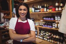 Portrait of female staff standing with arms crossed in super market — Stock Photo