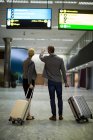 Low section of business people walking with luggage at airport terminal — Stock Photo