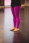 Low section of ballerina standing in ballet studio — Stock Photo