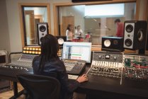 Audio engineer using sound mixer in recording studio — Stock Photo