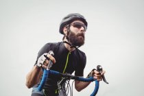 Determined athlete riding bicycle outdoors — Stock Photo