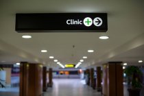 Close-up of clinic signboard at airport — Stock Photo