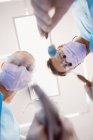 Low angle view of dentists holding dental tools at dental clinic — Stock Photo