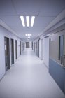 Empty hallway of a hospital with doors and lights — Stock Photo