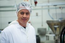 Portrait of butcher smiling at meat factory — Stock Photo