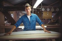 Front view of man making surfboard in workshop — Stock Photo