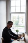 Людина, використовуючи ноутбук у вітальні на дому — стокове фото